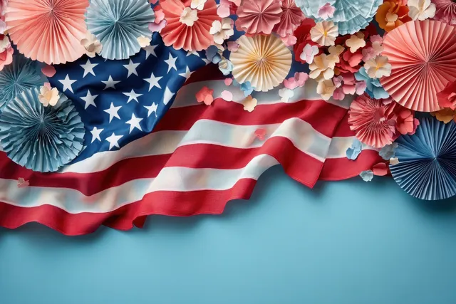 American flag draped over light blue background with colorful paper fan decorations and scattered flower petals.