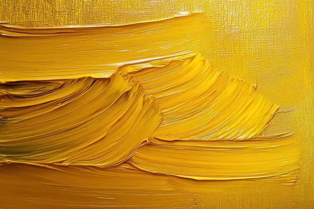 Thick yellow impasto paint strokes on canvas with layered ridges and smoothed sections
